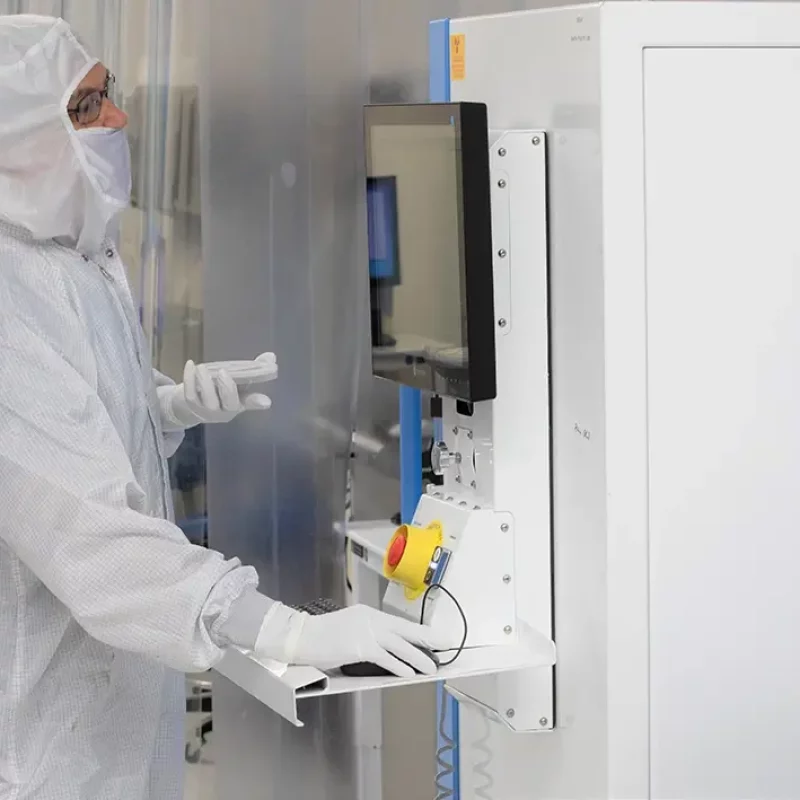 person in a clean suit in a lab using machinery
